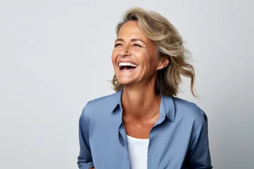 Foto op Plexiglas Closeup portrait of a happy senior business woman laughing against grey background © Chacmool