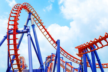 close-up image of a roller coaster track and the blue sky