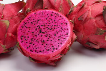 Ruby red exotic cactus dragon fruit whole cut half on white background - 768480641
