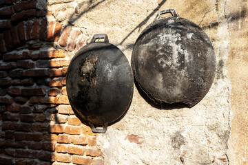 Old ancient dishes on cracked wall