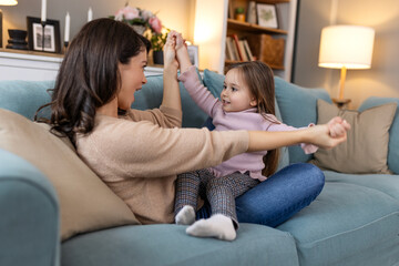 Young family, hug and portrait of child with mother, mom or mama bond, relax and enjoy quality time together. Love, happy family and woman with kid girl smile, care or lounge on home living room sofa