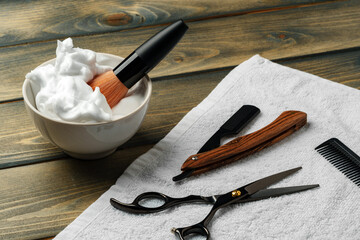 Hairdressing barber tools on wooden background close up