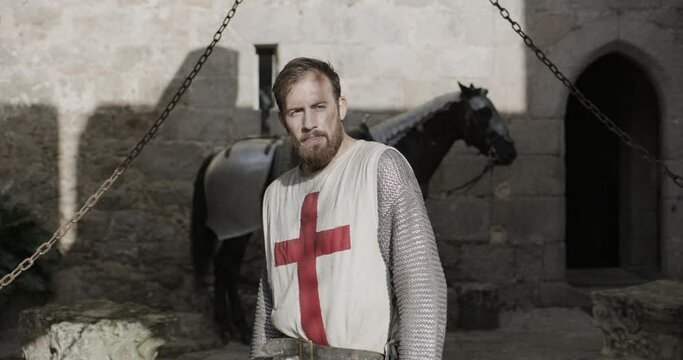 Cinematic dolly in on knight in 14th century castle
