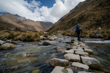 Naklejka premium lone trekker crossing a mountain stream on stepping stones