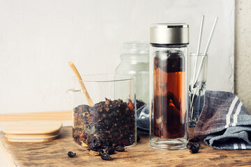 Rosehip tea, a drink in a bottle and dried rosehips.