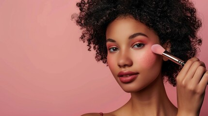 Flawless Beauty Portrait of a Model Applying Blush with Makeup Brush on a Soft Pink Background