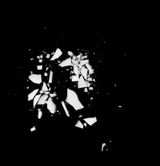Debris or fragments of white porcelain isolated on black. White glass explosion on black background.