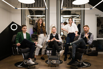 Portrait of a professional barbershop team. Five hairdressers stylists boys and girls after work.