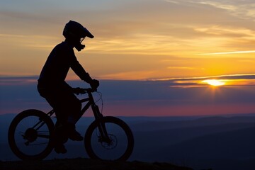 Obraz premium silhouette of biker at dawn on a hilltop, sun cresting horizon