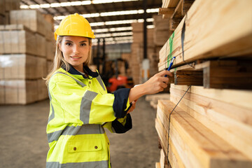 Portrait Caucasian business woman checking wood stock with clipboard at timber wood warehouse	 - 768518611