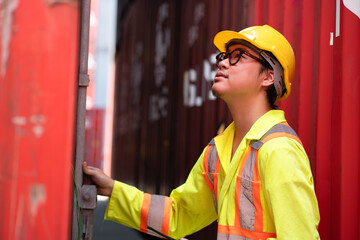 Asia logistic engineer man worker or foreman working with checking container at container site	 - 768518631