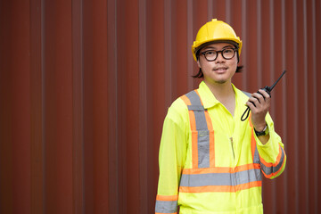 Confident Asia logistic engineer man worker or foreman working with walkie talkie at container site	 - 768518694