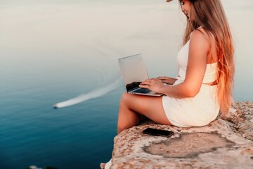 Freelance women sea working on the computer. Good looking middle aged woman typing on a laptop...