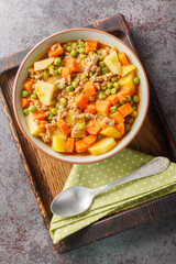 Turkish food Green Peas with Ground Beef stew Kiymali Bezelye closeup on the plate on the table. Vertical top view from above