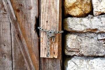 lock on the door of an old farmhouse. Closed Old vintage wood Door with door lock 