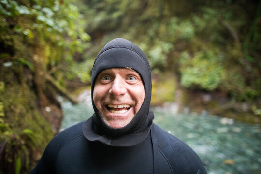 Portrait of man in wetsuit making a happy funny face