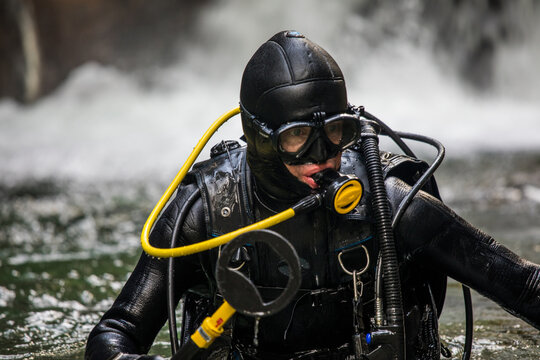 Portrait of scuba diver holding a small metal detector