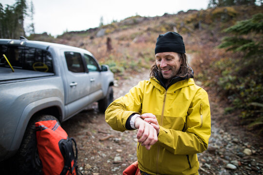 Active man starts activity tracking on his watch before a hike