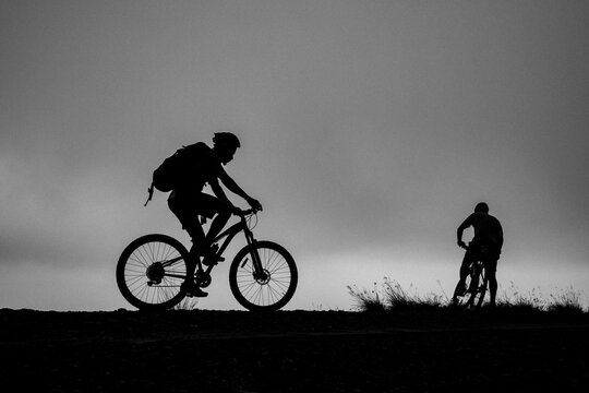 Two cyclists silhouetted against the sky, Rwanda