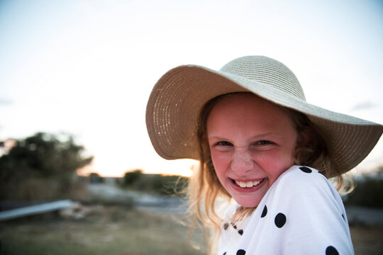 Silly Face Blonde Girl in Straw Hat at Sunset on Vacation in Anguilla