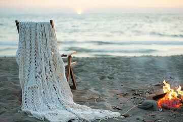 knitted dress draped over beach chair, bonfire flickering nearby