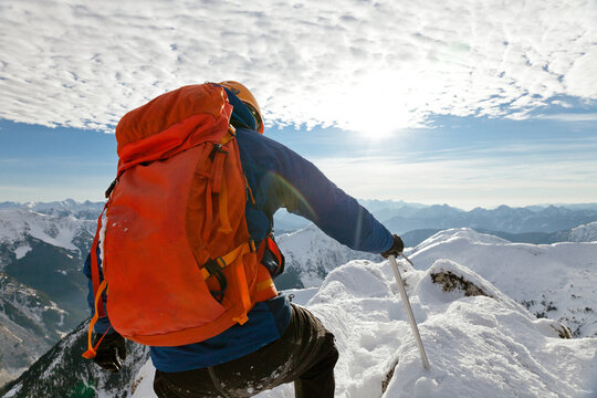 First person view of a backpacker approaching mountain summit