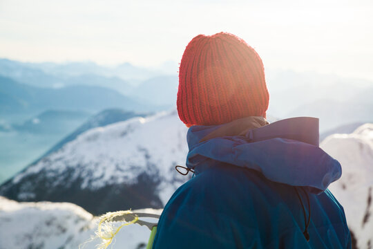 Rear view of active man looking out at view from mountain summit