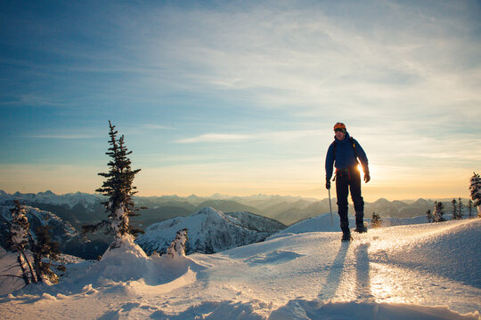 silhouette of mountain climber crossing a mountain ridge