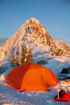 tent set up below snow covered summit of Needle Peak, B.C..
