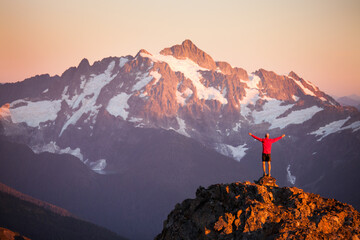 Hiker reaches summit in North Cascades National Park.