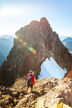 Rear view of climber approaching a mountain summit