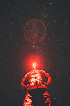 Low angle of man wearing Infrared headlamp at night, starry sky