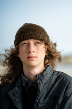 Portrait of young adult looking off frame with long hair