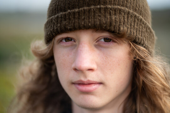 Close up portrait of teen looking into camera with calm expression