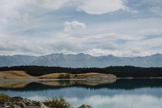 Outdoor background with reflected image in water of mountain scape