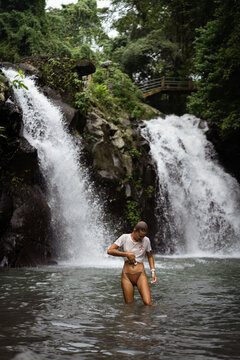 Young woman at Aling-Aling waterfall. Bali