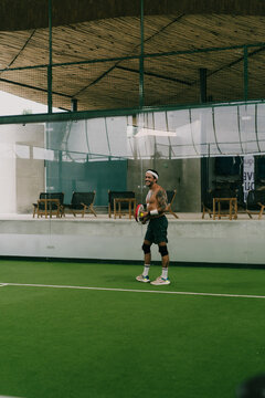 Man play padel tennis on an indoor court, Bali.