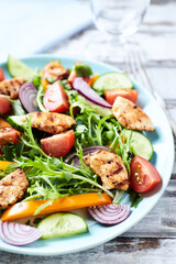 Healthy Salad with Chicken Breast, Cherry Tomatoes, Cucumber, Orange Pepper, Endive and Red Onion. Close up.	