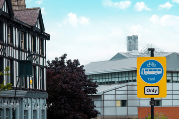 UK Road sign cycle, bus and taxi only against a city road © Iryna