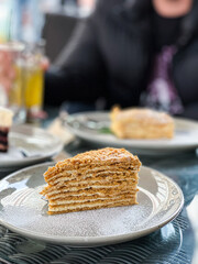 Cake slice on plate with powdered sugar, a delectable baked good