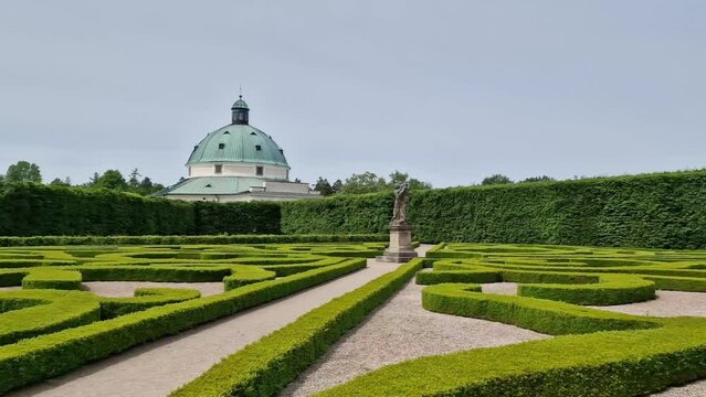 Landscape of Kvetna zahrada garden in Kromeriz, Czech Republic with pavillion in the background, wide angle panning shot