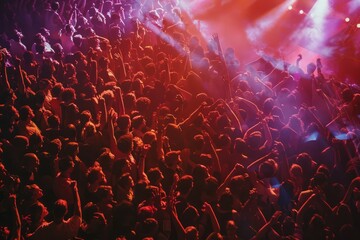 A top-down view of a massive crowd standing in front of a stage during a live event - obrazy, fototapety, plakaty