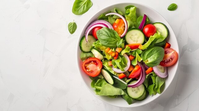 An image of a bowl filled with a delicious vegetable salad on a white background, viewed from the top