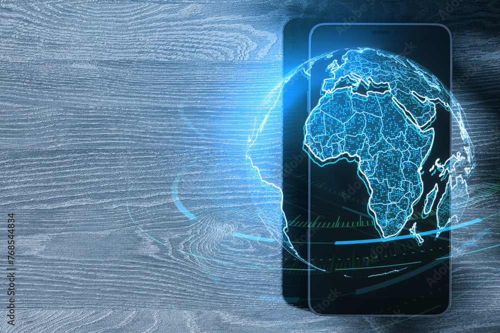 Aufkleber close up of smartphone with glowing futuristic blue globe hologram on wooden desk with mock up place