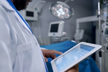 surgeon consulting digital tablet with patients records in or - obrazy, fototapety, plakaty