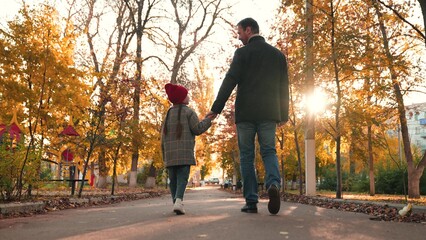 Little daughter shares observations and dreams with father during pleasant walk. Father and...