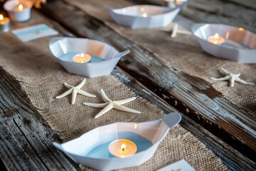 rustic table with burlap runners, starfish escort cards, and tealight boats - obrazy, fototapety, plakaty