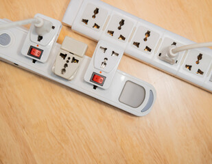 Top view of plugs in extension cords - from the Offset collection on wooden table.