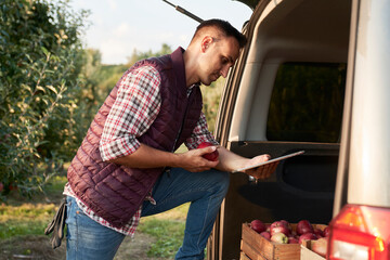 Sales representative using digital tablet in transportation car