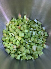Metal bowl filled with chopped rhubarb and apples, natural foods ingredients
